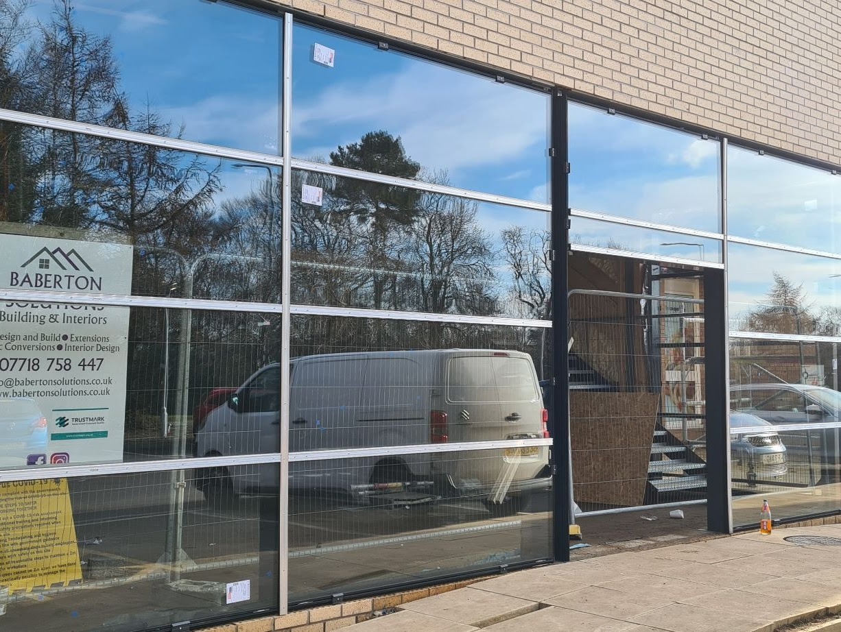 Full-height aluminium curtain walling system with structural mullions and reflective glazing on commercial elevation