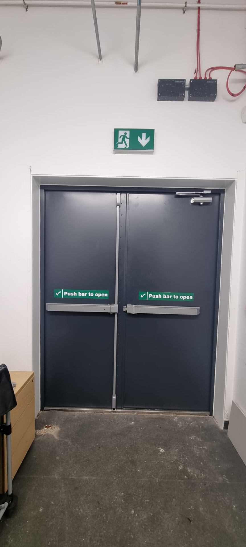 Steel double fire doors interior with twin stainless push bars and overhead closer
