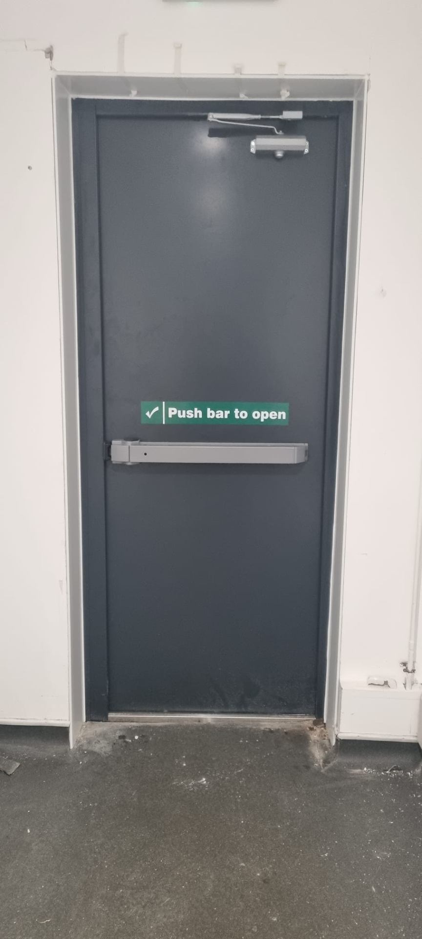 Single steel fire door with push bar and overhead closer, plant-room elevation