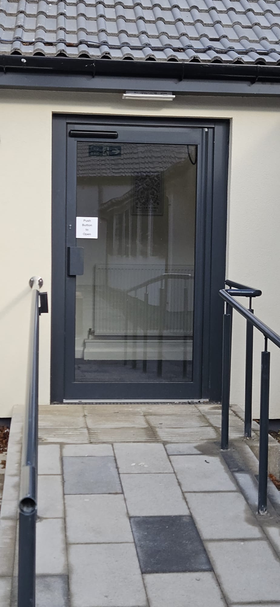 Aluminium glazed entrance with side-light to single-storey community building