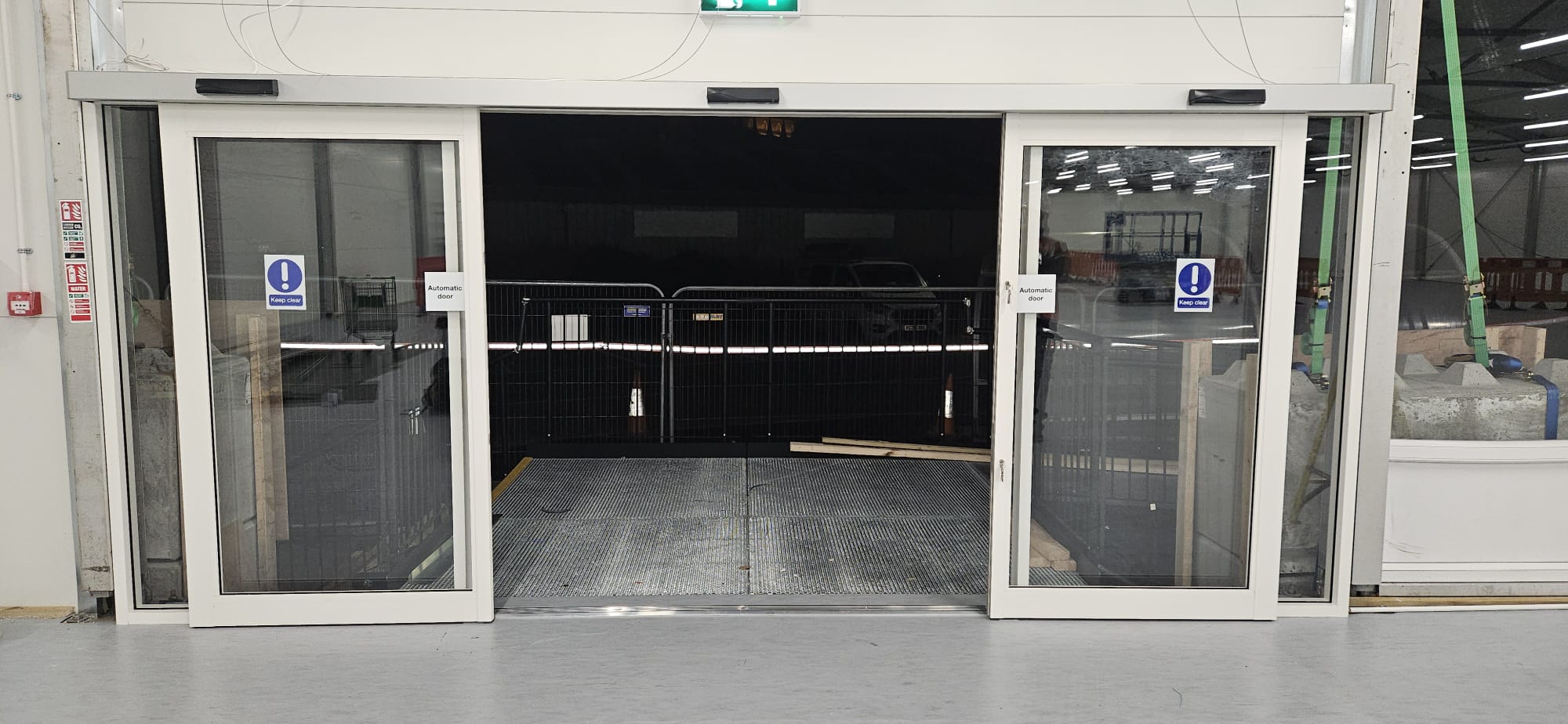 Twin pairs of automatic sliding doors at goods entrance — open position