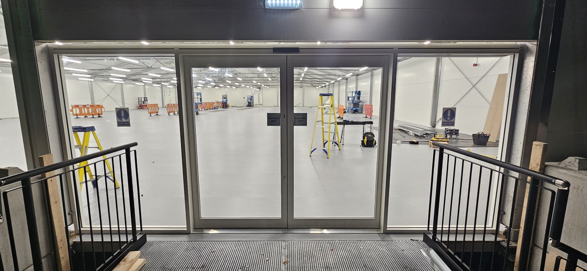 Pair of automatic sliding doors at distribution centre interior