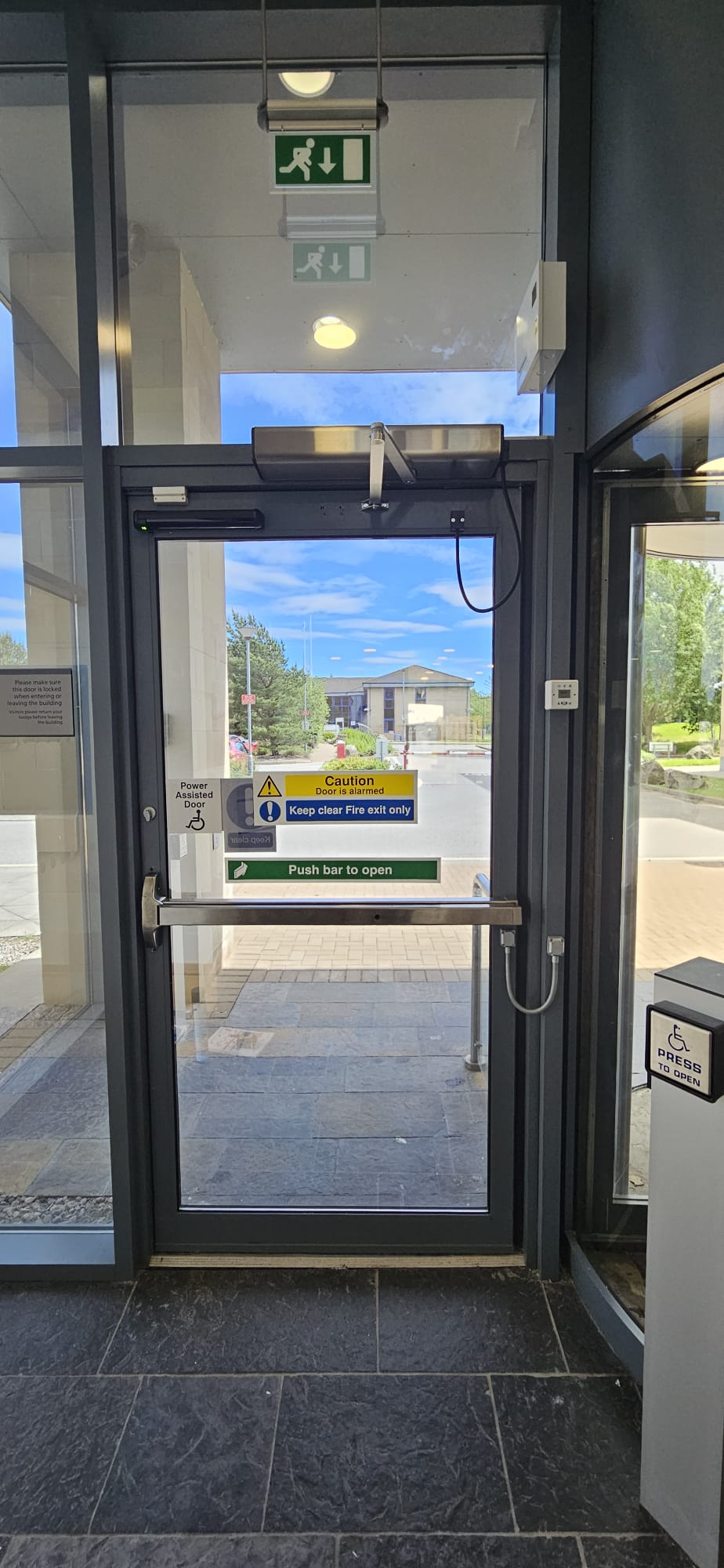 Single power-assisted glazed entrance door with stainless push handle