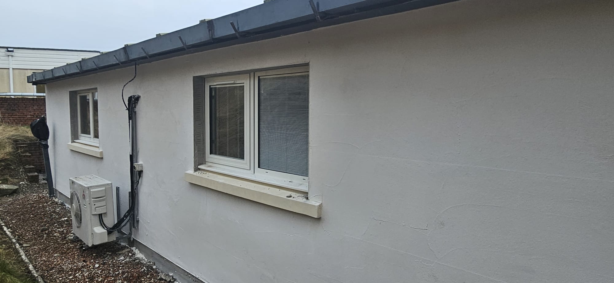 External UPVC commercial windows on rendered elevation with grey trims