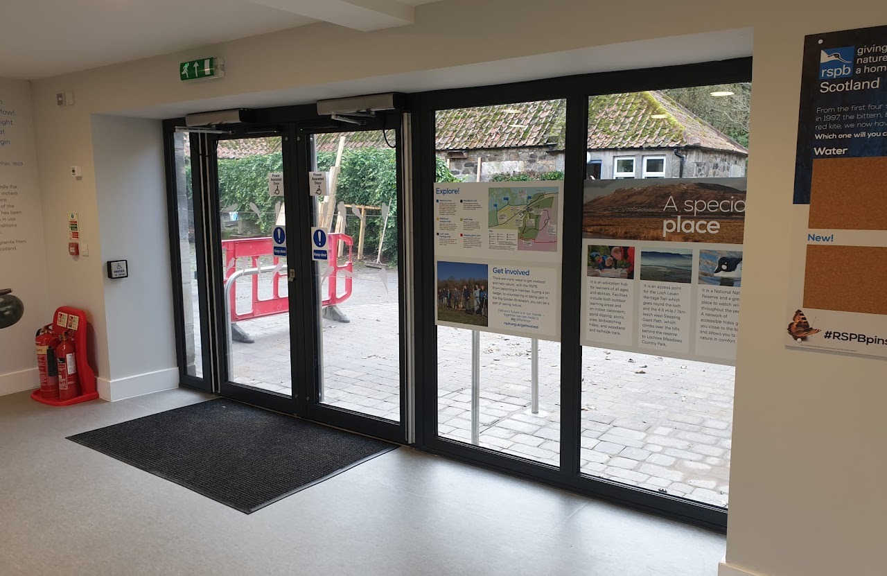 Power-assisted aluminium entrance doors at visitor centre interior